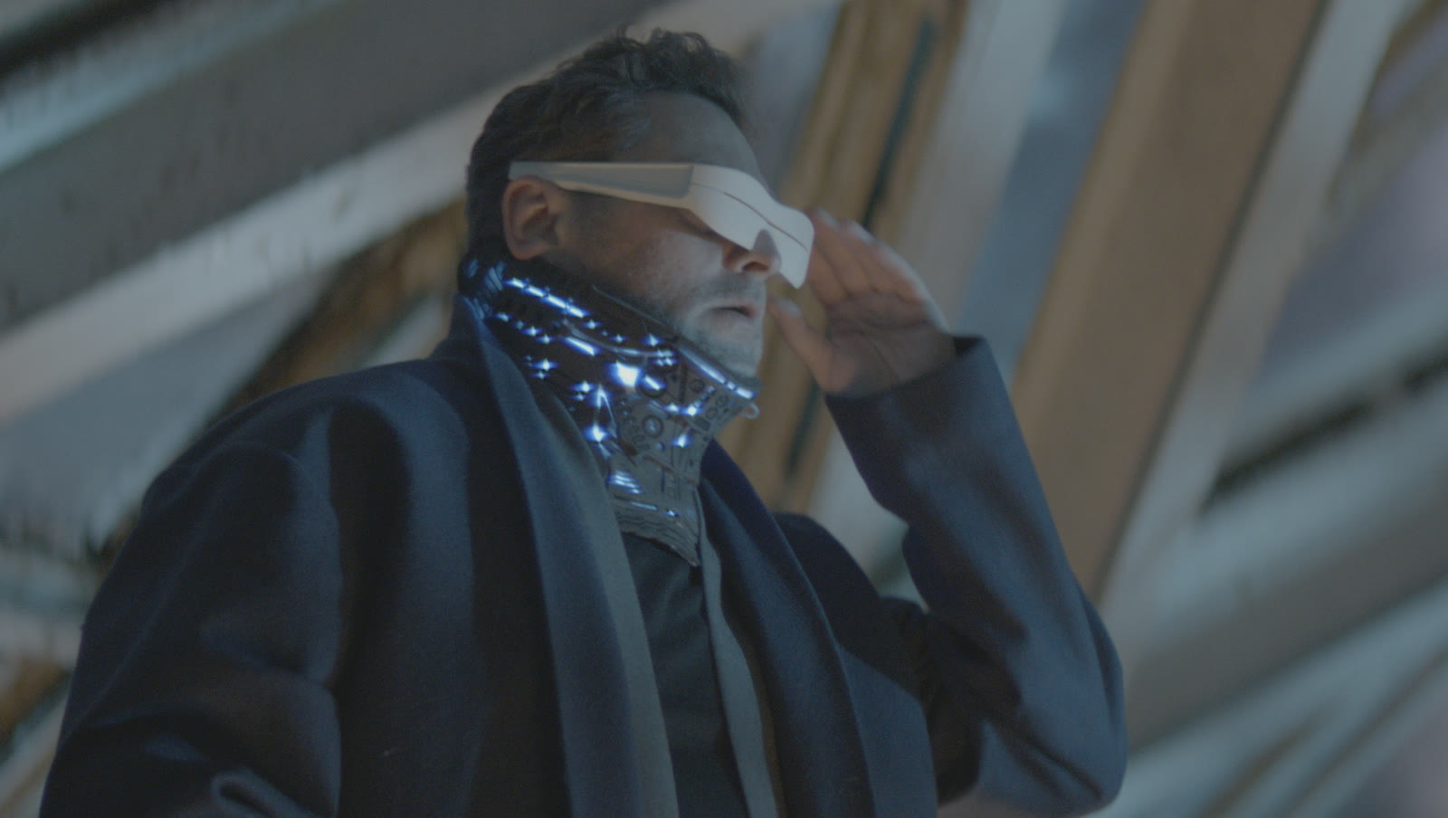 A man wearing a Chronoscope visor, neon neural collar glowing
