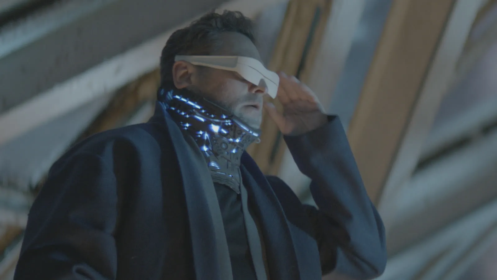 A man wearing a Chronoscope visor, neon neural collar glowing